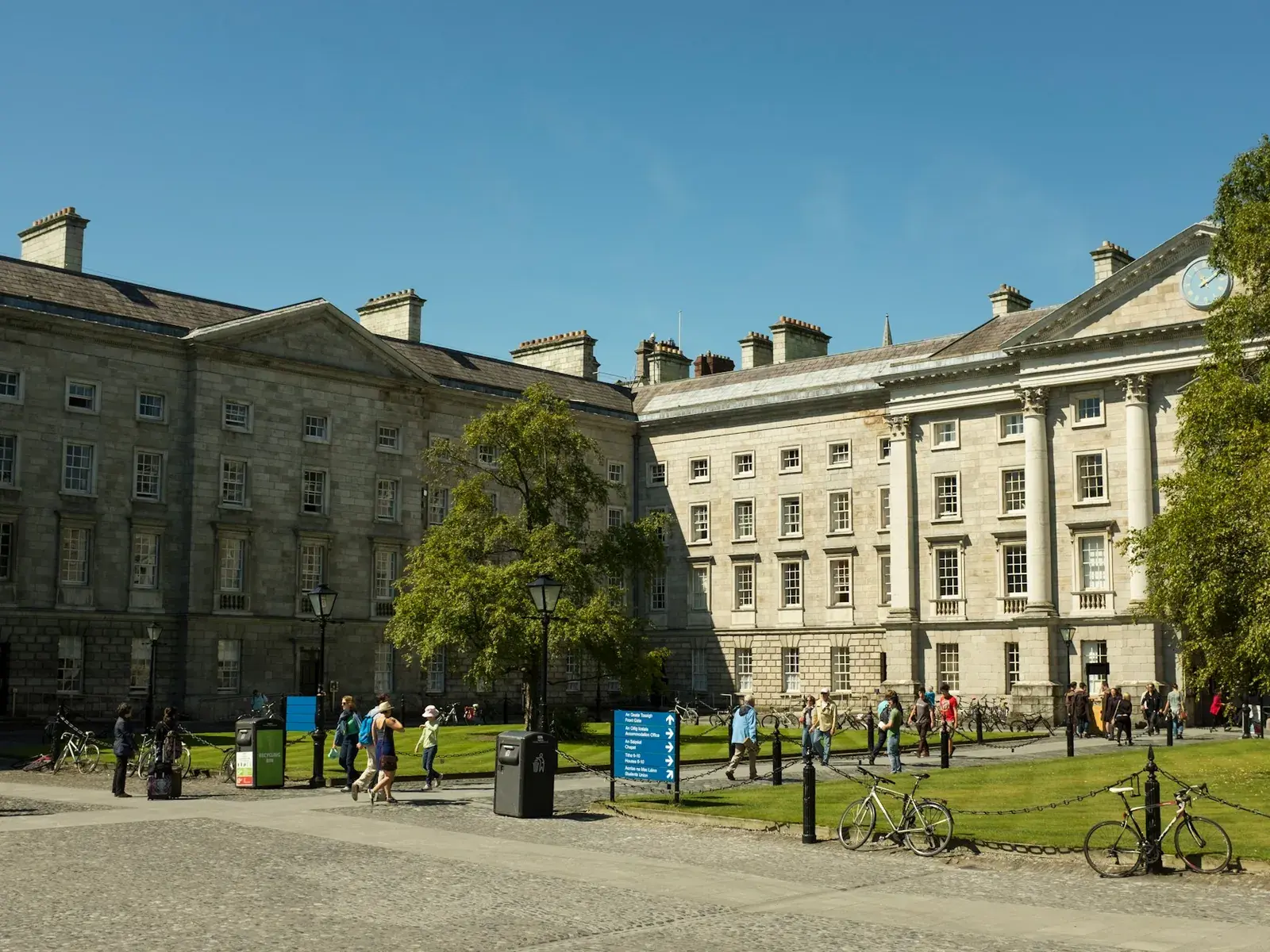 Students walking through the historic Trinity College Dublin campus