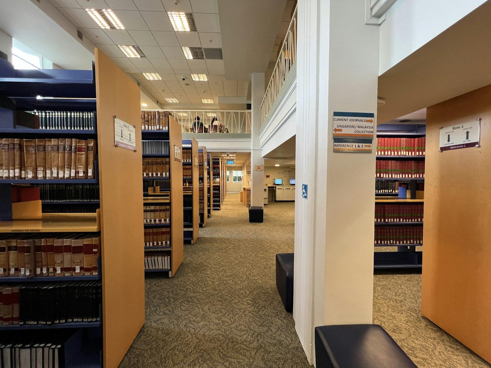 Rows of books and study desks inside a university library