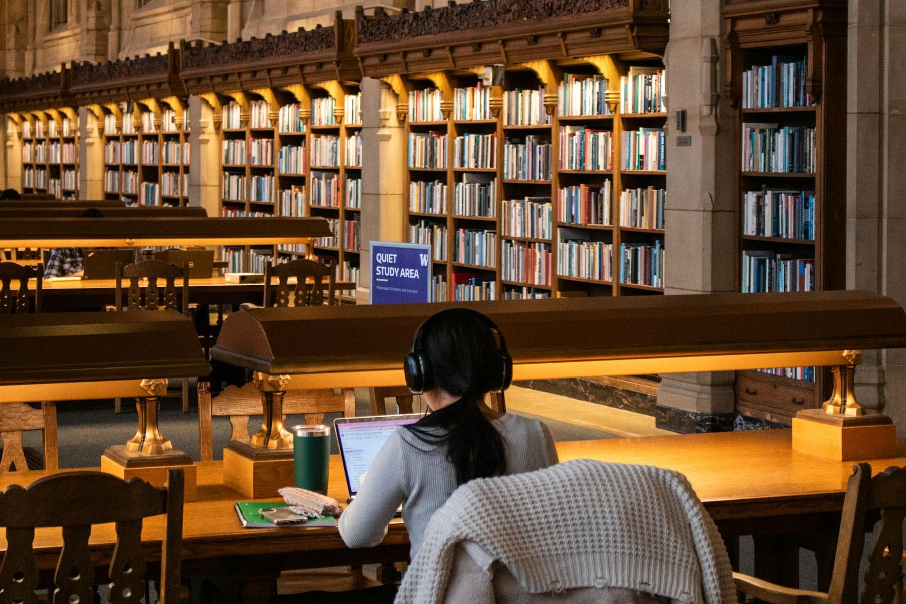 A student studying in a historic university library